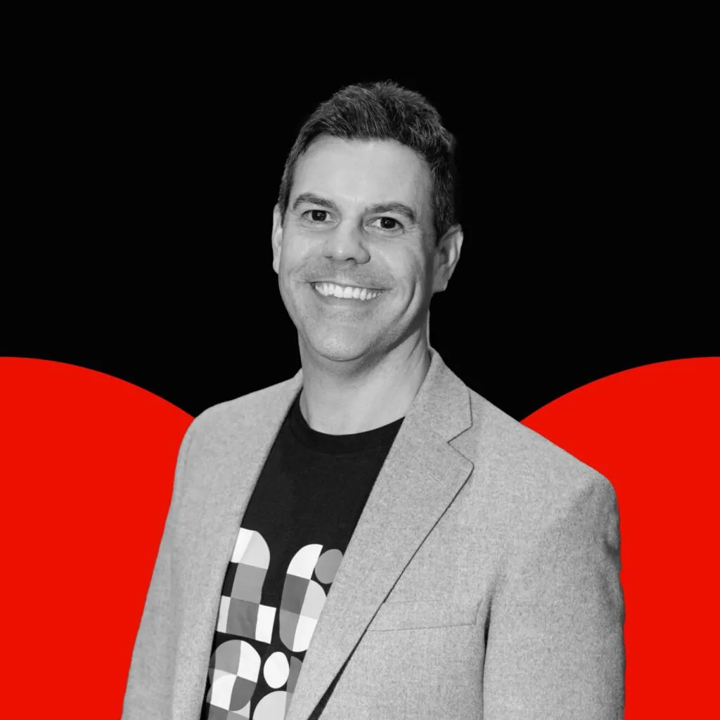 Photo of Keith Scandone on black background with red semi circles
