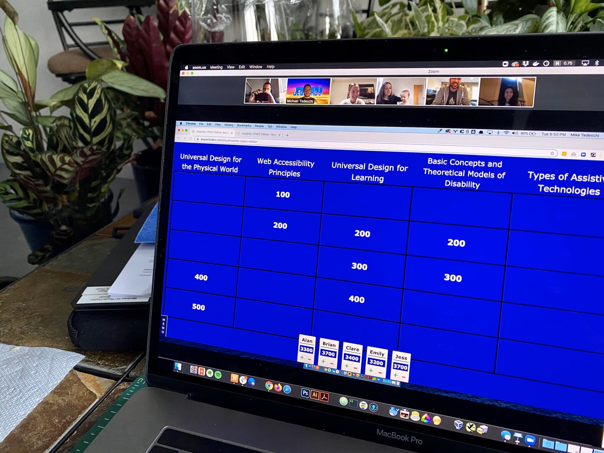 A laptop with shared screen showing an Accessibility-themed Jeopardy game.