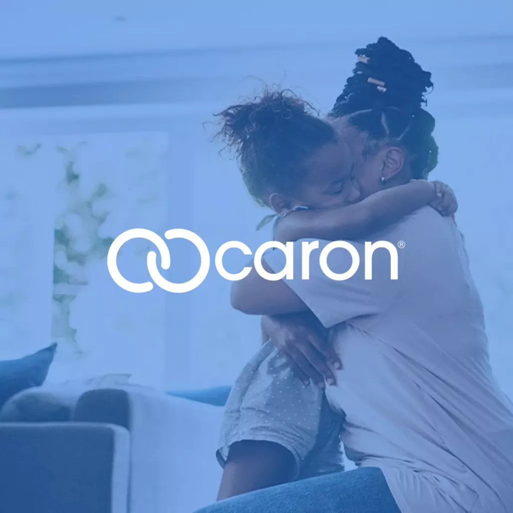 Caron logo over blue overlay photo of woman and child hugging.