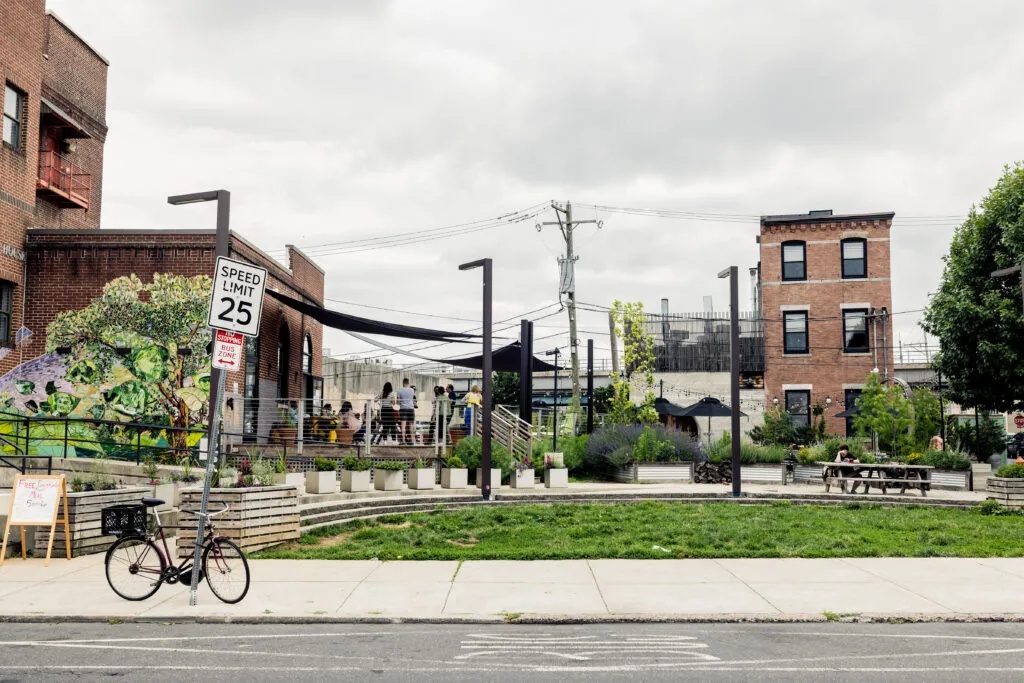 Brick buildings, a picnic table, and green space, only a few buildings down from the O3 office.