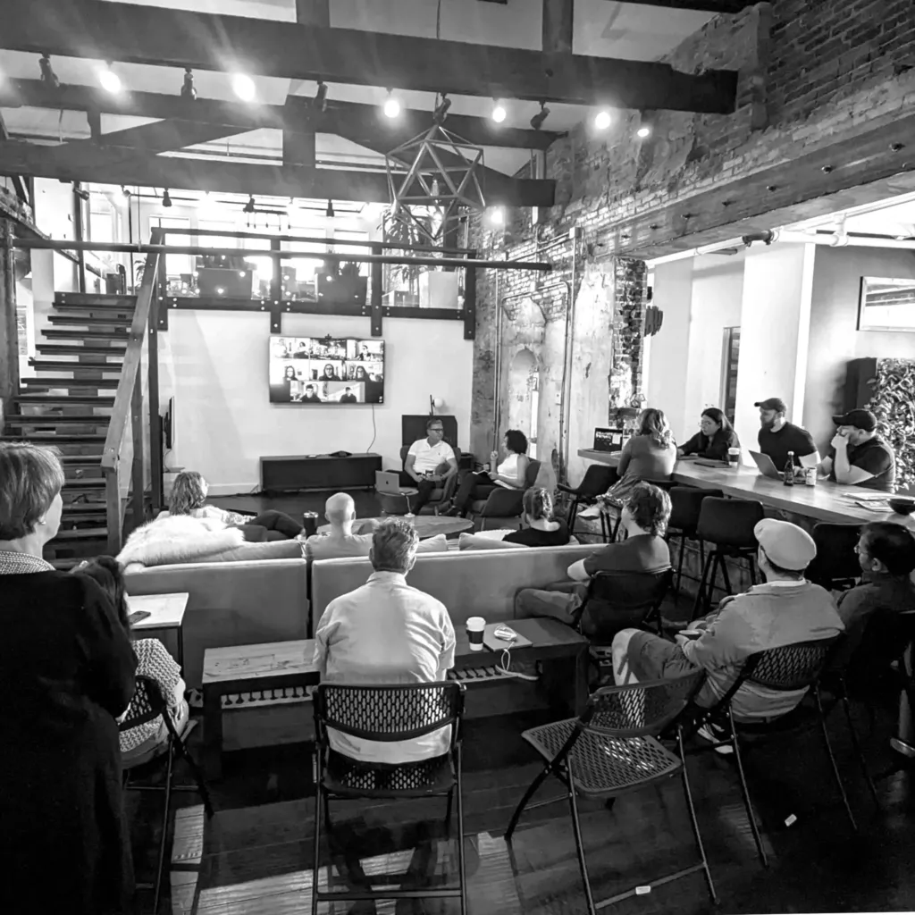 Image of O3 offices with 2 people in a conversation and others listening